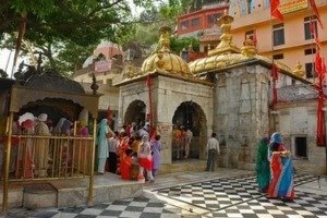 A group of tourists stands outside a temple in India, capturing the essence of cultural exploration and travel.