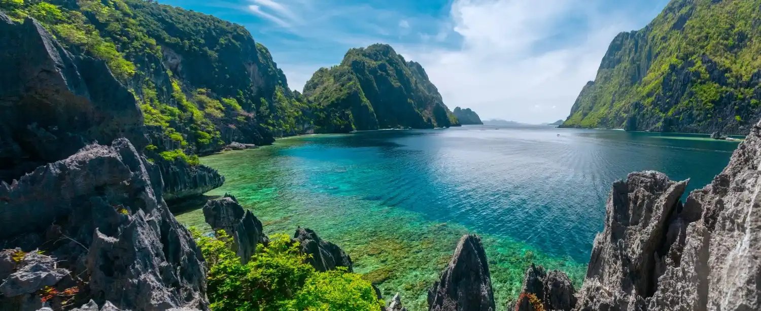 Stunning blue waters of Coron Lagoon in El Nido, Philippines, showcasing a tropical paradise for travelers and explorers.